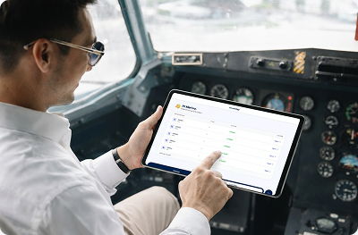 Pilot reviewing flight data on a tablet in the cockpit